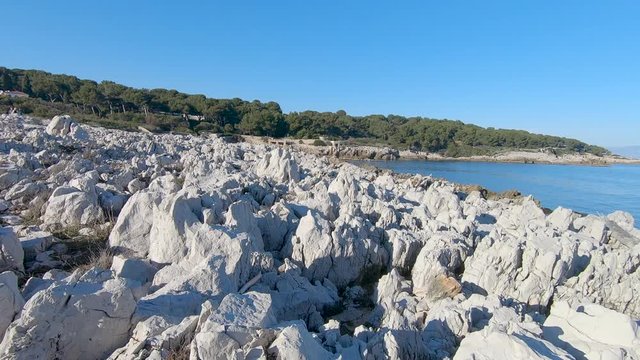Panning footage of a rocky beach on the Antibes coastline in South of France.