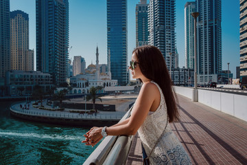 Fototapeta na wymiar Happy beautiful tourist woman in Dubai marina