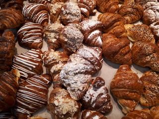  fresh sweet tasty pastry with colorful glaze and powder and almond crumbs