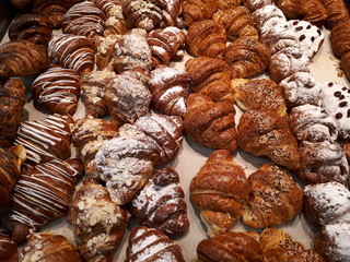  fresh sweet tasty pastry with colorful glaze and powder and almond crumbs