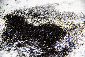 A black glitter on the white background