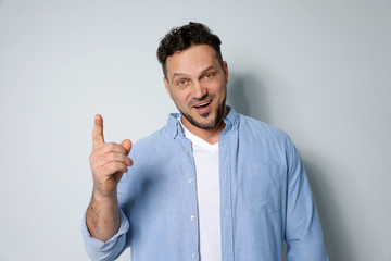 Portrait of handsome man on light grey background