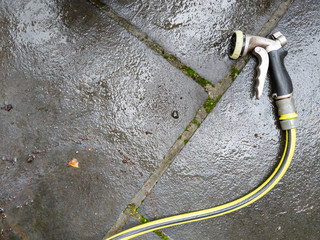 high angle view of hose nozzle on patio - Powered by Adobe