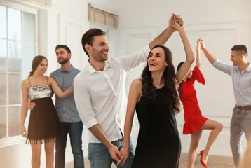 Fotobehang Lovely young couple dancing together at party © New Africa