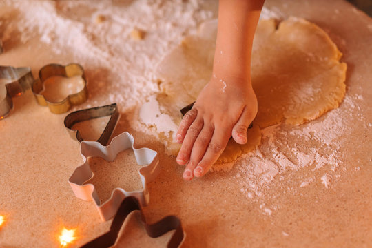 Hand Of A Little Boy Making Traditional Christmas Cookies.