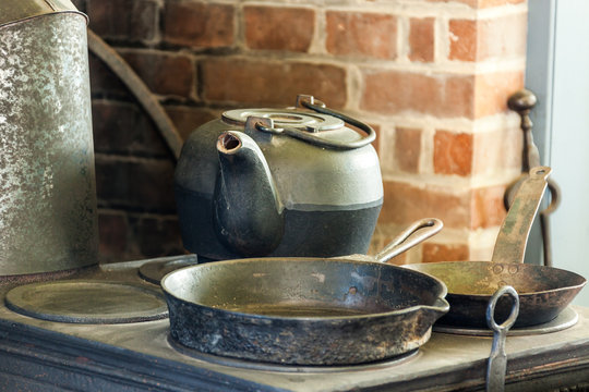 Beautiful vintage pots and pans on old stove.