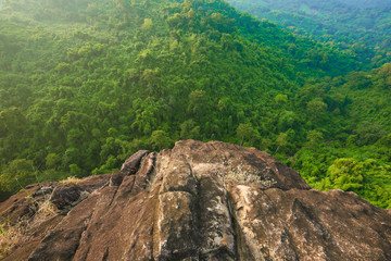 Looking down the cliff have forest background © pungpuiwa