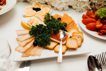 Restaurant table with many dishes with food on it. Food Table Celebration Delicious Party Meal Concept. A lot of food. Served for wedding, anniversary, other holiday. Banquet dishes in the restaurant