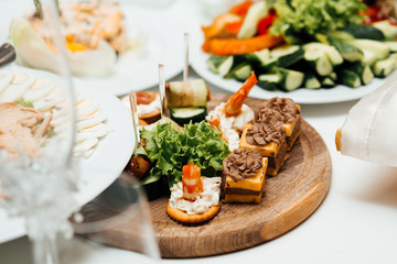 Elegant and luxurious event arrangement. Wedding. Decorated catering banquet table. Food for party. Delicious cuisine menu in tasty food restaurant. Table for banquets, weddings, partie