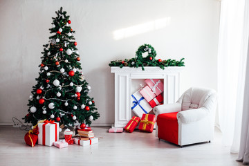 Christmas tree with lights garlands adorned with new year holiday gifts