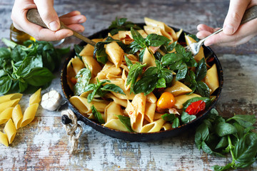One pan pasta with basil. Vegan pasta. Selective focus. Macro. - obrazy, fototapety, plakaty