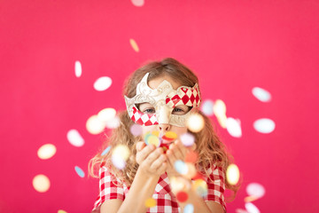 Fancy girl blowing confetti against pink bakground - obrazy, fototapety, plakaty