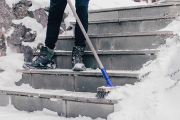 Snow removal from the stairs to the house after snowfall