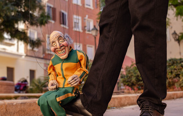 Old Man Runner Puppet in Tracksuit Sit on Foot