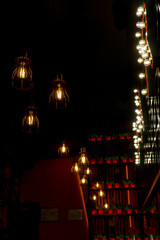 Obraz premium Minimalistic lamps decorated cafe in a modern loft style. Yellow color light. Blurred background as hallway.