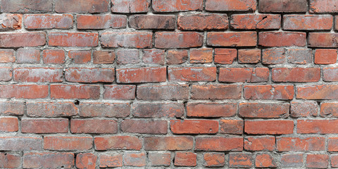 A panorama of weathered exposed bricks 
