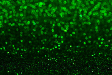 Christmas abstract texture, green sparkles bokeh shining background.
