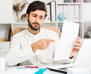 Office worker holding paper with contract