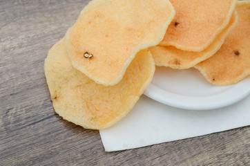 Closeup of crunchy prawn crackers in a white plate