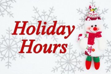 Fototapeta na wymiar Holiday hours message with snowman with snowflakes