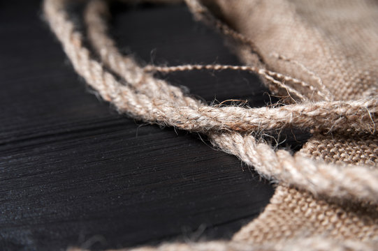 Twine And Burlap On A Black Wooden Background, Still Life