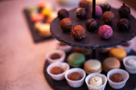 Macaroons And Chocolates On Two Tiered Party Platter