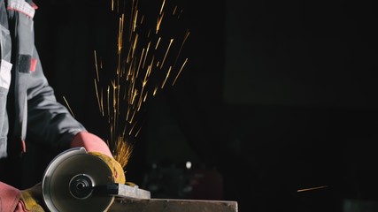 Forge workshop. Smithy manual production. Close up details of sparks, industrial worker using angle...