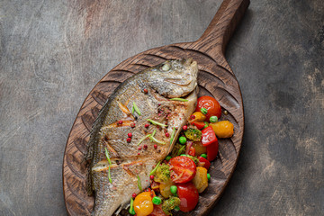 Close view of pan fried dorado fish with vegetables