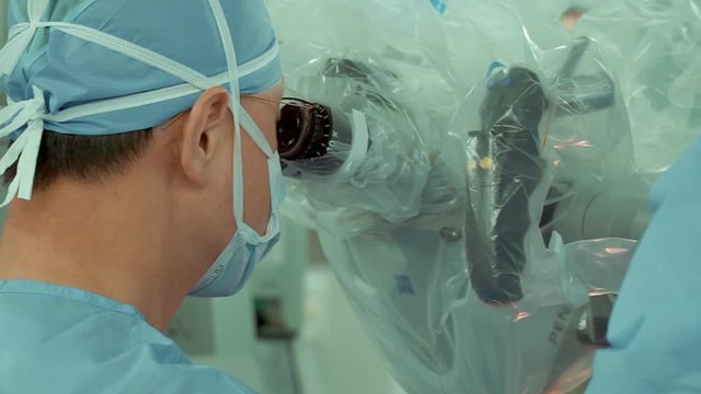 Surgeon performs surgery on human skull through electron microscope