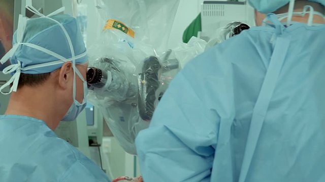 Surgeon performs surgery on human skull through electron microscope