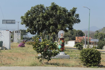 Juchitan, Oaxaca. Sculpture of a woman. Landscape