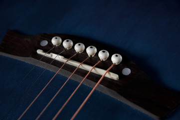 guitar neck with strings close-up on a black wooden background
