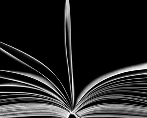 white silhouette of an open book on a black background