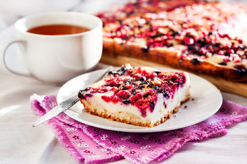 Tasty breakfast. Delicious pie with berries and cottage cheese an a cup of tea