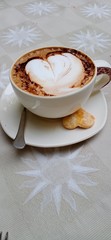cup of coffee and cookies on wooden table