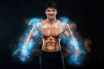 Fototapeta na wymiar Athlete bodybuilder. Strong muscular man pumping up muscles with dumbbells on black background. Workout bodybuilding concept. Copy space for sport nutrition ads.