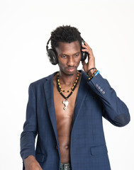 A black guy (man) in a blue jacket and jeans is listening music with headphones