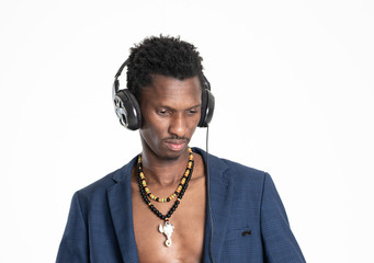 A black guy (man) in a blue jacket and jeans is listening music with headphones