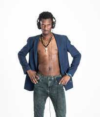 A black guy (man) in a blue jacket and jeans is listening music with headphones