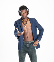 A black guy (man) in a blue jacket and jeans is listening music with headphones