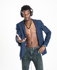 A black guy (man) in a blue jacket and jeans is listening music with headphones