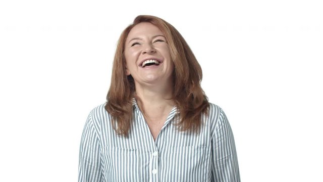 Slow-mo charming, elegant mature caucasian redhead woman, adult female with red haircut, start laughing and smiling, chuckling from funny niece playful attitude, giggle joyfully, white background