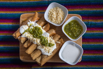 Tacos dorados de pollo típicos mexicanos casero salsa verde  tostada