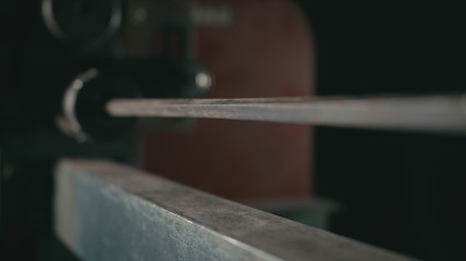 Forge workshop on table. Smithy manual production. Metal pipe craft electric twist wrought iron machine. The blacksmith makes iron products for manufacture of fireplaces, stoves.