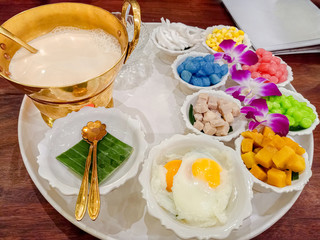 Thai Dessert name Bualoy or ( Bua Loy ) Rice balls colourful in sweet creamy coconut milk syrup and eggs . Bua loy is the best dessert menu recommended in Thailand.