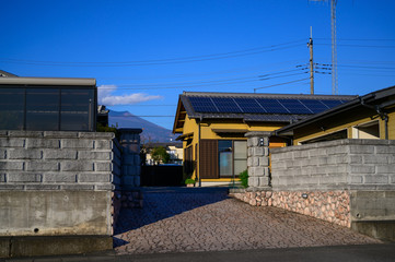 Newly build houses in the Japan with solar panels attached on the roof against a sunny sky Close up of new building black solar panels.Zonnepanelen Translation: Solar panel, Sun energy