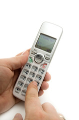 Man Dialing a Wireless Home Phone on White Background