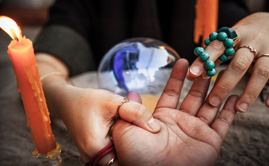 Fortune telling casts a spell, witchcraft with Magic crystal ball in Ceremony . Concept of Astrology, Horoscope and alchemy , Maya magic , superstition , predictions and  mysterious mystical . - obrazy, fototapety, plakaty