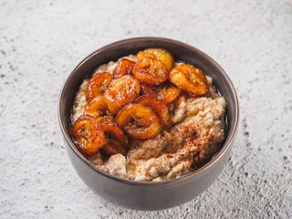 Oatmeal with fried banana. White background table