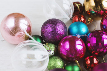 Winter holidays background  christmas tree decorations, christmas balls and toys. On a white wooden background. Selective focus, top view - bright colorful holiday atmosphere.
